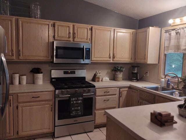 5664 Hall Rd, Muskegon, MI 49442 - kitchen with appliances with stainless steel finishes, light countertops, light tile patterned floors, and light brown cabinetry