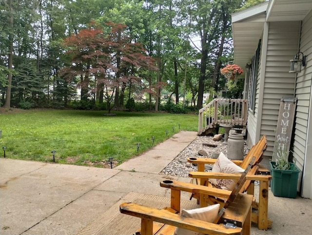 5664 Hall Rd, Muskegon, MI 49442 - view of green lawn featuring a patio area and view of wooded area