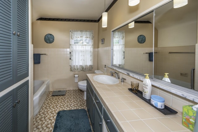 1217 Westmoorland St, Ypsilanti, MI 48197 - bathroom featuring a wainscoted wall, tile walls, vanity, and a tub to relax in