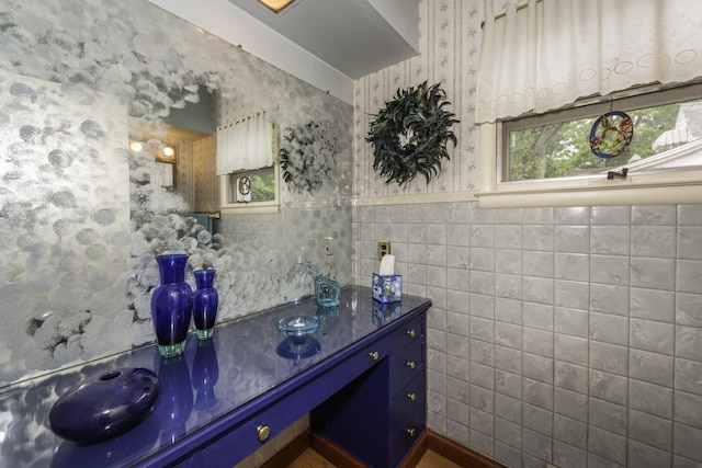 1217 Westmoorland St, Ypsilanti, MI 48197 - bathroom with tile walls, vanity, wallpapered walls, and wainscoting