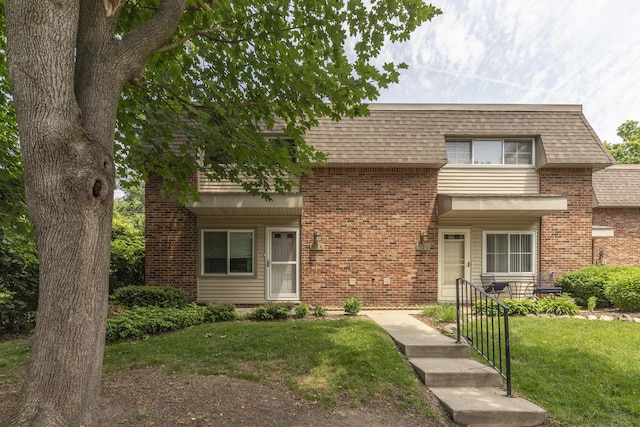 517 Longshore Dr Unit A, Ann Arbor, MI 48105 - view of front of property featuring brick siding, a front lawn, and mansard roof
