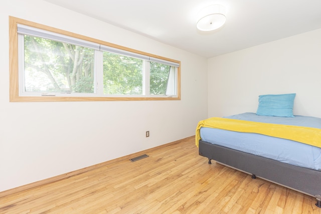 517 Longshore Dr Unit A, Ann Arbor, MI 48105 - bedroom featuring multiple windows and wood finished floors