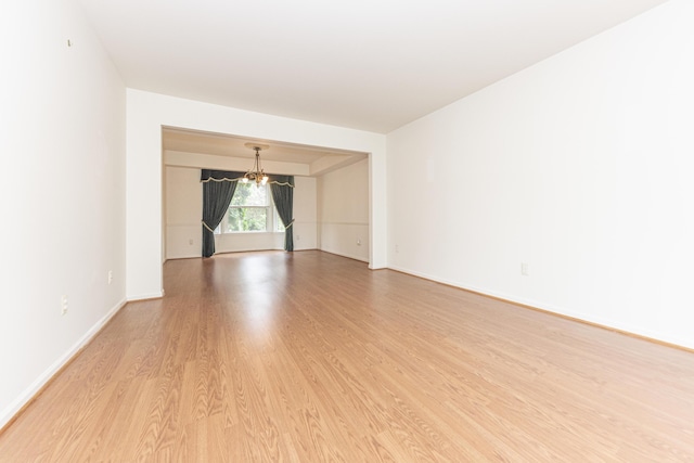5835 S Ashford Way, Ypsilanti, MI 48197 - spare room featuring a chandelier and light wood-style flooring