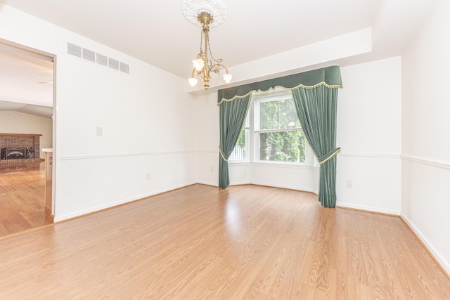 5835 S Ashford Way, Ypsilanti, MI 48197 - empty room featuring a chandelier and wood finished floors