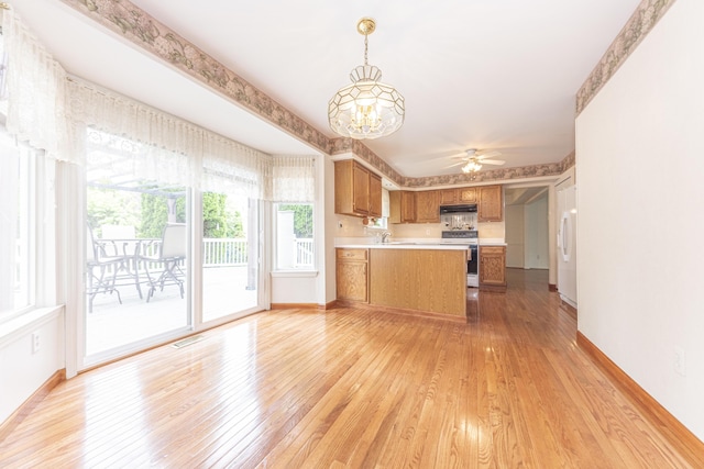 5835 S Ashford Way, Ypsilanti, MI 48197 - kitchen featuring white appliances, light wood finished floors, brown cabinets, and light countertops