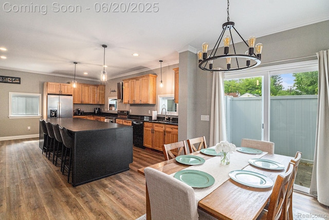 3280 Chambourne St, Ferndale, MI 48382 - kitchen featuring stainless steel appliances, dark countertops, dark wood finished floors, crown molding, and a chandelier