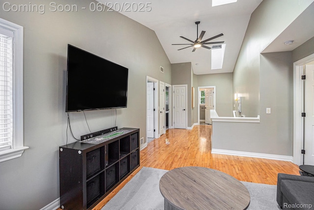 3280 Chambourne St, Ferndale, MI 48382 - living area with a ceiling fan, light wood-style floors, a skylight, and vaulted ceiling