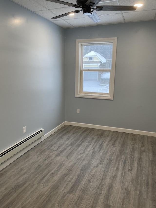 251 Page St NE, Grand Rapids, MI 49505 - spare room with a paneled ceiling, a ceiling fan, a baseboard radiator, and wood finished floors