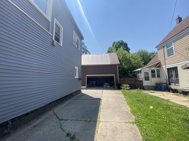251 Page St NE, Grand Rapids, MI 49505 - view of side of home featuring an attached garage, concrete driveway, and a lawn
