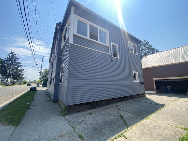 251 Page St NE, Grand Rapids, MI 49505 - view of side of property with concrete driveway and crawl space