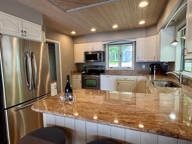 68121 Edgewater Beach Rd, White Pigeon, MI 49099 - kitchen featuring appliances with stainless steel finishes, light stone countertops, a peninsula, wood ceiling, and white cabinets