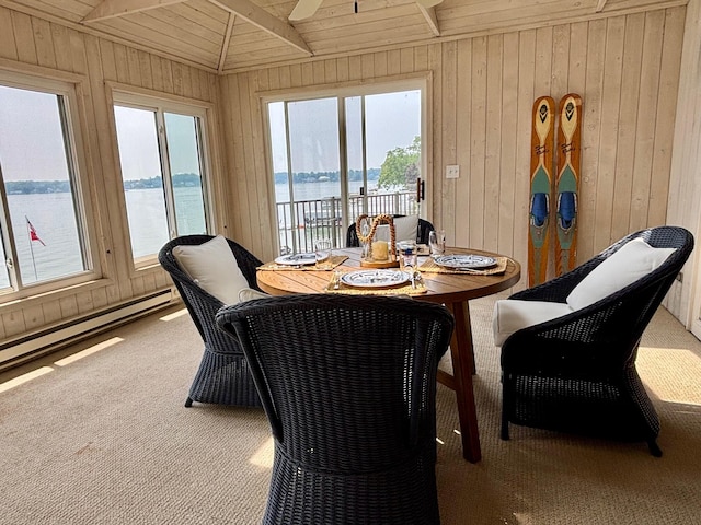 68121 Edgewater Beach Rd, White Pigeon, MI 49099 - dining space with a water view, wood walls, carpet, and healthy amount of natural light