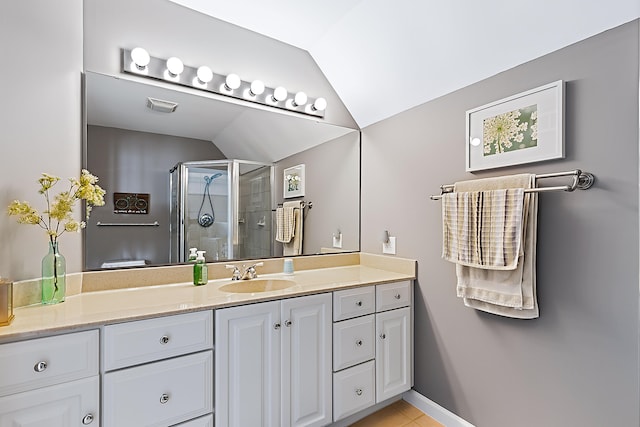 68121 Edgewater Beach Rd, White Pigeon, MI 49099 - full bathroom featuring vaulted ceiling, vanity, a stall shower, and tile patterned floors
