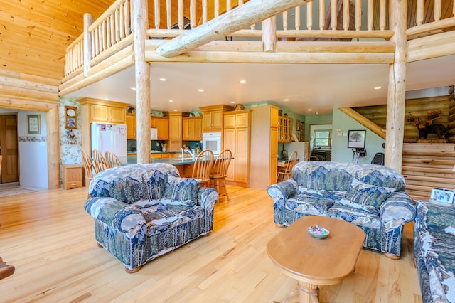 7111 Gilbert Rd, Pittsford, MI 49271 - living area with a towering ceiling, rustic walls, light wood-type flooring, and recessed lighting