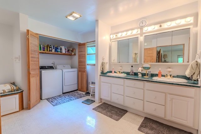 7111 Gilbert Rd, Pittsford, MI 49271 - bathroom with washing machine and dryer, double vanity, and tile patterned floors