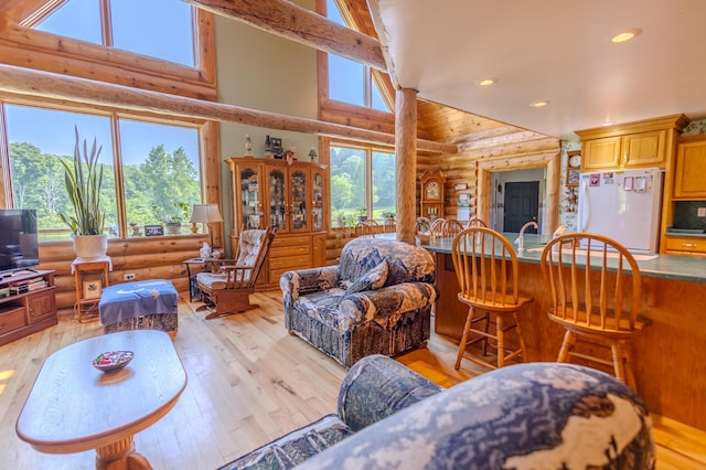 7111 Gilbert Rd, Pittsford, MI 49271 - living area with rustic walls, high vaulted ceiling, light wood-style floors, and recessed lighting