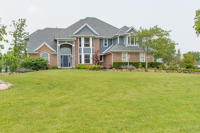 5284 Green Pine Ln, Kalamazoo, MI 49009 - view of front of house featuring a front yard, brick siding, and a shingled roof