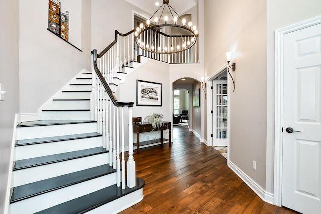 5284 Green Pine Ln, Kalamazoo, MI 49009 - entryway featuring arched walkways, hardwood / wood-style flooring, stairway, a chandelier, and crown molding