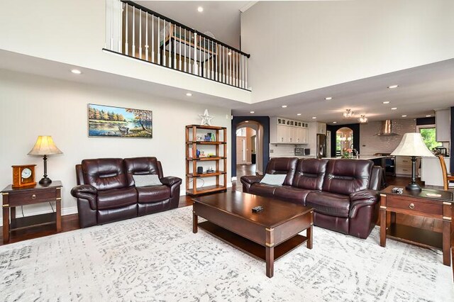 5284 Green Pine Ln, Kalamazoo, MI 49009 - living area with arched walkways, recessed lighting, a high ceiling, and wood finished floors