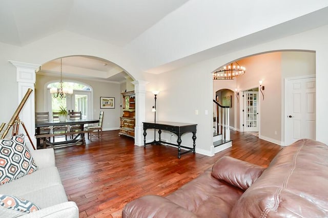 5284 Green Pine Ln, Kalamazoo, MI 49009 - living room with arched walkways, a chandelier, wood finished floors, and stairs