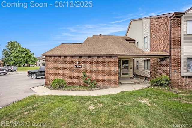 6700 Ridgefield Cir Unit 201, West Bloomfield, MI 48322 - rear view of property with brick siding, a lawn, and a shingled roof