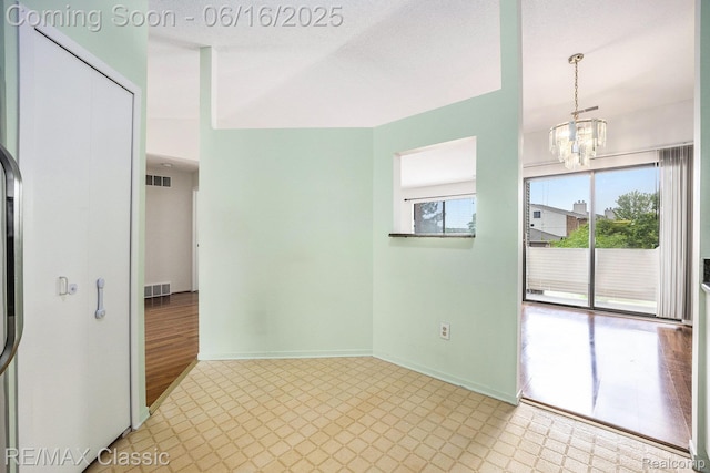6700 Ridgefield Cir Unit 201, West Bloomfield, MI 48322 - spare room featuring light floors and a chandelier