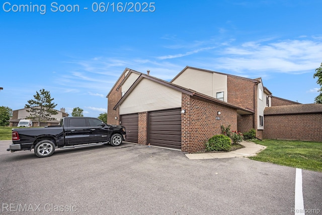6700 Ridgefield Cir Unit 201, West Bloomfield, MI 48322 - view of side of home with brick siding and a garage