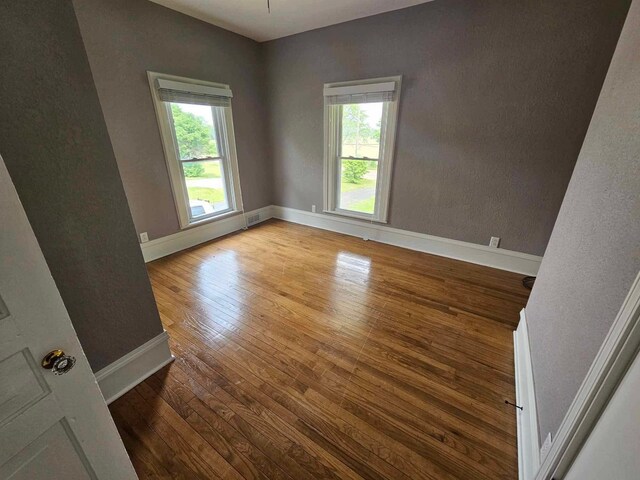 20051 Capital Ave NE, Battle Creek, MI 49017 - spare room with plenty of natural light and hardwood / wood-style floors