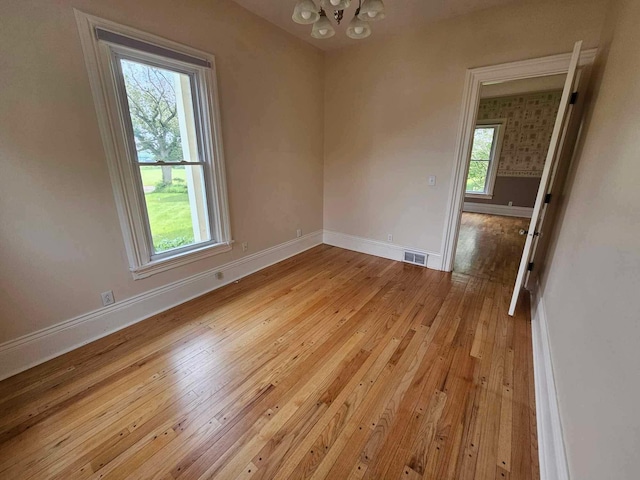 20051 Capital Ave NE, Battle Creek, MI 49017 - empty room with a chandelier and light wood finished floors