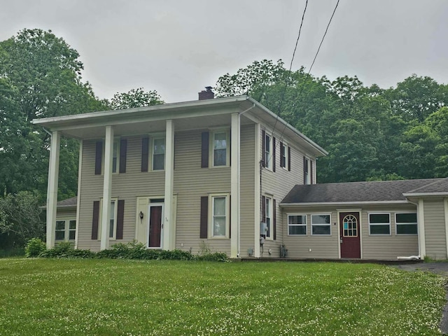 20051 Capital Ave NE, Battle Creek, MI 49017 - view of front facade featuring a chimney and a front lawn
