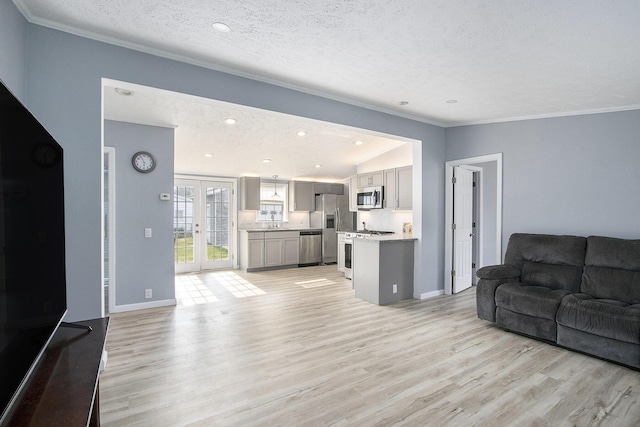 42 S 25th St, Battle Creek, MI 49015 - living area with crown molding, light wood finished floors, a textured ceiling, and vaulted ceiling