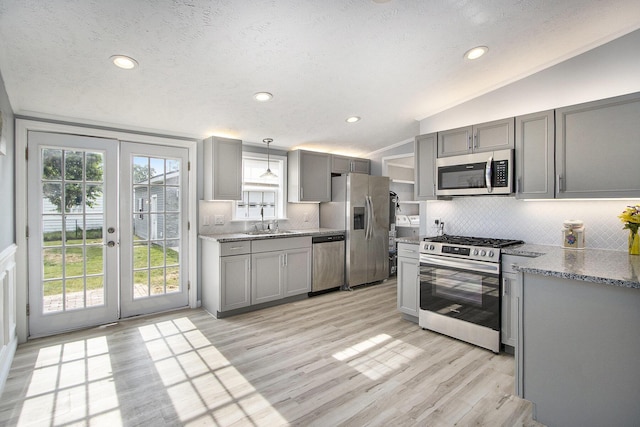 42 S 25th St, Battle Creek, MI 49015 - kitchen featuring stainless steel appliances, gray cabinetry, french doors, tasteful backsplash, and light wood-style floors