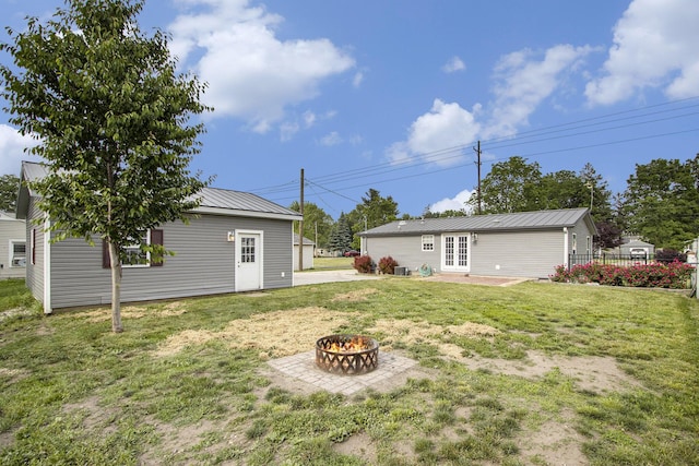 42 S 25th St, Battle Creek, MI 49015 - view of grassy yard with a fire pit and french doors
