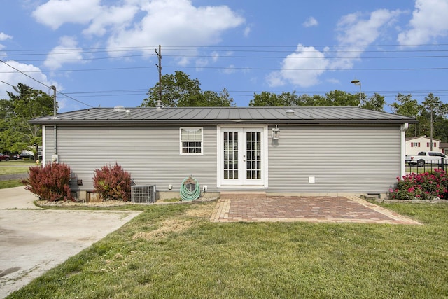 42 S 25th St, Battle Creek, MI 49015 - rear view of property with a standing seam roof, a lawn, and french doors