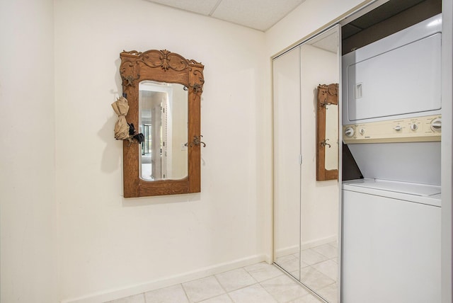 225 W Columbia Ave Unit 6, Battle Creek, MI 49015 - washroom featuring stacked washing machine and dryer and light tile patterned floors