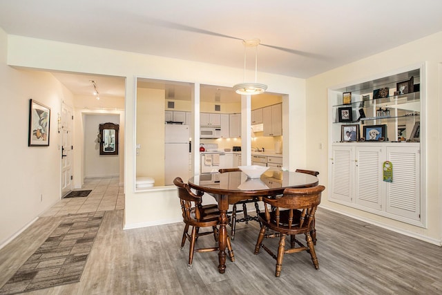 225 W Columbia Ave Unit 6, Battle Creek, MI 49015 - dining area featuring light wood-style floors and baseboards
