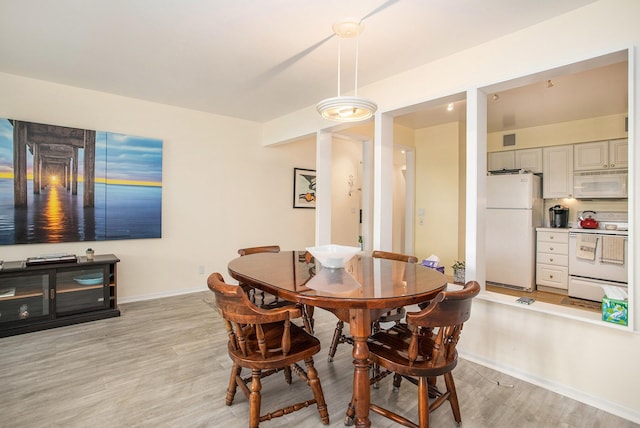 225 W Columbia Ave Unit 6, Battle Creek, MI 49015 - dining area with light wood-style flooring and baseboards