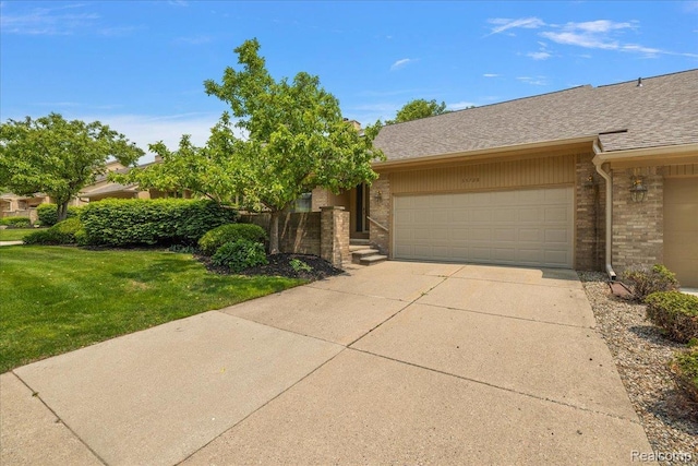 55728 Lorraine Dr Unit 20, Utica, MI 48316 - view of front facade featuring an attached garage, brick siding, driveway, a front lawn, and a shingled roof