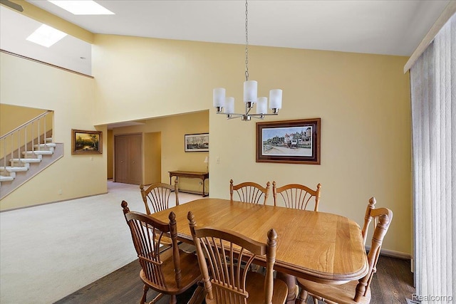 55728 Lorraine Dr Unit 20, Utica, MI 48316 - dining area with stairway, a chandelier, wood finished floors, and vaulted ceiling