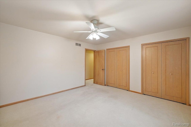 55728 Lorraine Dr Unit 20, Utica, MI 48316 - unfurnished bedroom with multiple closets, light colored carpet, and a ceiling fan