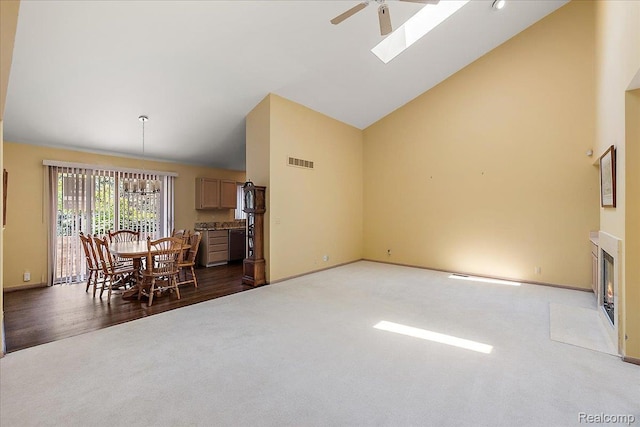 55728 Lorraine Dr Unit 20, Utica, MI 48316 - carpeted dining room featuring ceiling fan, high vaulted ceiling, and a skylight