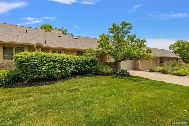 55728 Lorraine Dr Unit 20, Utica, MI 48316 - view of green lawn featuring driveway and a garage