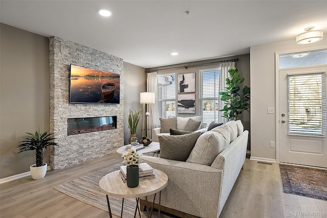164 Jotham Ave, Auburn Hills, MI 48326 - living room featuring wood finished floors, a stone fireplace, and recessed lighting