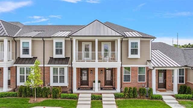 164 Jotham Ave, Auburn Hills, MI 48326 - townhome / multi-family property with a standing seam roof, a metal roof, brick siding, and a balcony