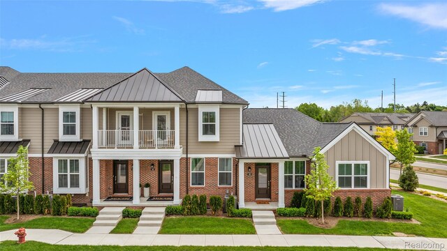 164 Jotham Ave, Auburn Hills, MI 48326 - view of property featuring a standing seam roof, brick siding, a balcony, covered porch, and a metal roof