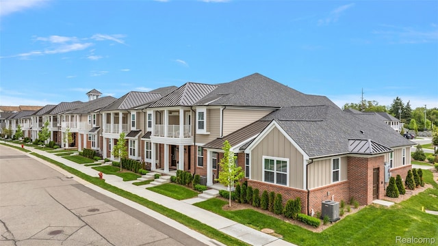164 Jotham Ave, Auburn Hills, MI 48326 - townhome / multi-family property featuring brick siding, a standing seam roof, a residential view, board and batten siding, and a metal roof