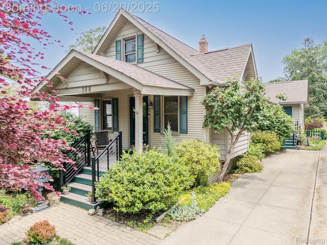 108 High St, Clawson, MI 48017 - bungalow featuring a shingled roof, covered porch, and a chimney