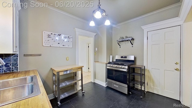 108 High St, Clawson, MI 48017 - kitchen with stainless steel range with gas cooktop, dark tile patterned flooring, crown molding, white cabinetry, and backsplash