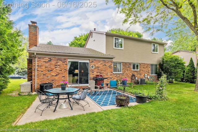 3184 Cedar Key Dr, Lake Orion, MI 48360 - rear view of house featuring brick siding, a patio area, a chimney, a lawn, and roof with shingles