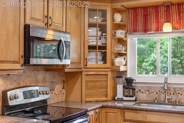 3184 Cedar Key Dr, Lake Orion, MI 48360 - kitchen featuring appliances with stainless steel finishes, backsplash, glass insert cabinets, and stone countertops